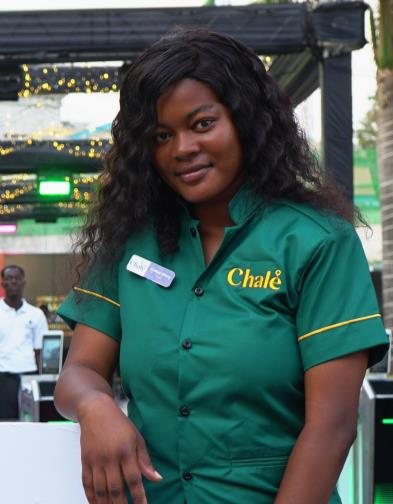 Chalé App crew member in a green uniform shirt looking at the camera