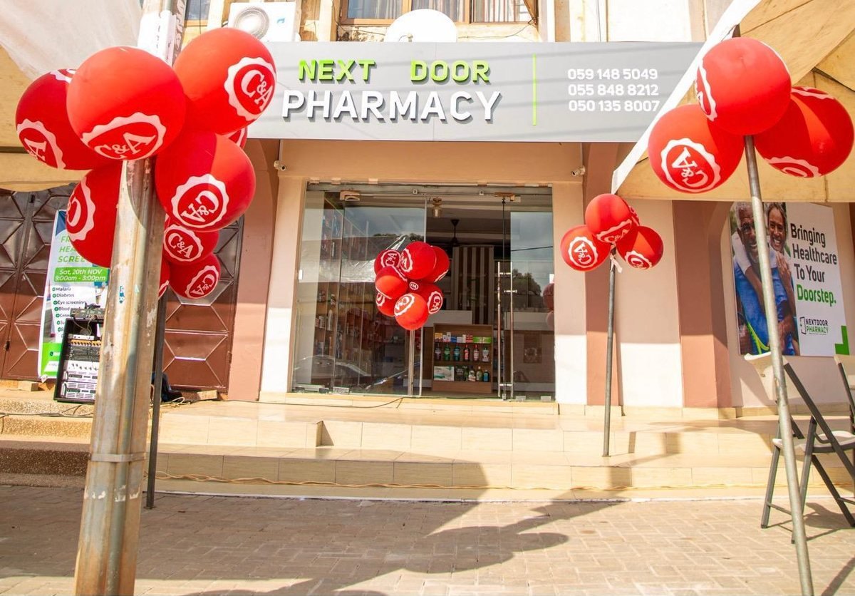 The Next Door Pharmacy shopfront decorated with red balloons